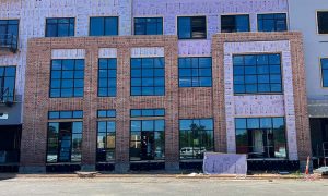 Business building with brick veneer masonry with inset windows