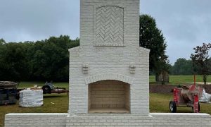 White brick masonry fireplace set outside